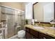 Well-lit bathroom with a granite vanity and a glass enclosed shower and seat at 6110 Read Rd, Suwanee, GA 30024