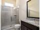 A bathroom features glass enclosed shower, granite topped vanity and neutral decor at 6110 Read Rd, Suwanee, GA 30024