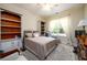 Bright bedroom with a large window, built-in bookcases, and neutral decor at 6110 Read Rd, Suwanee, GA 30024