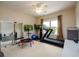 Bonus room with ceiling fan, television, trampoline, weights and exercise equipment at 6110 Read Rd, Suwanee, GA 30024