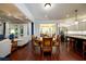 Open floor plan with a dining area featuring hardwood floors, chandelier, and kitchen access at 6110 Read Rd, Suwanee, GA 30024