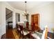 Formal dining room with dark wood floors and staircase view, featuring a china cabinet at 6110 Read Rd, Suwanee, GA 30024