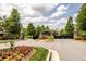 Stone entrance gate to The Reserve community with landscaping and manicured flowers at 6110 Read Rd, Suwanee, GA 30024