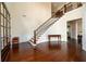 Grand foyer featuring gleaming hardwood floors, staircase with elegant iron railings, and high ceilings at 6110 Read Rd, Suwanee, GA 30024