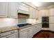 Gourmet kitchen featuring granite counters, stainless appliances and classic white cabinetry at 6110 Read Rd, Suwanee, GA 30024