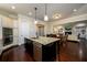 Open-concept kitchen with granite countertops, stainless appliances, and center island with seating at 6110 Read Rd, Suwanee, GA 30024