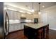 Gourmet kitchen with granite counters, stainless appliances, and dark wood floors and island at 6110 Read Rd, Suwanee, GA 30024