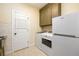 Functional laundry room with modern appliances, storage, and sink at 6110 Read Rd, Suwanee, GA 30024