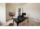 Spacious home office featuring a large window, black desk, and comfortable leather furniture at 6110 Read Rd, Suwanee, GA 30024