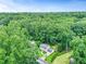 An aerial view of a home surrounded by vibrant green trees, showcasing a well-kept lawn at 3605 Hickory Se Cir, Smyrna, GA 30080