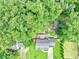 Aerial view of a house featuring a backyard deck surrounded by lush, green trees and landscaping at 3605 Hickory Se Cir, Smyrna, GA 30080