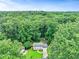 Charming home nestled in a lush, green forest setting with a well-manicured lawn and a red roof at 3605 Hickory Se Cir, Smyrna, GA 30080