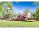 This landscaped backyard includes a spacious deck, screened porch, and lush green lawn at 3605 Hickory Se Cir, Smyrna, GA 30080