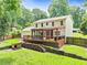 Expansive backyard featuring a back porch, fire pit, woodpile, dog house, and mature landscaping at 3605 Hickory Se Cir, Smyrna, GA 30080