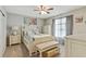 This bedroom features an inviting bed with a bench, a ceiling fan, and natural light through the window at 3605 Hickory Se Cir, Smyrna, GA 30080