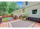 Outdoor deck with railing, features a woven outdoor rug and wooded view at 3605 Hickory Se Cir, Smyrna, GA 30080