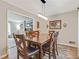 Traditional dining room featuring wood floors, neutral paint, and modern light fixture with open floorplan at 3605 Hickory Se Cir, Smyrna, GA 30080