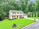 Traditional two-story home with a well-kept lawn, a two-car garage, and mature trees in the background at 3605 Hickory Se Cir, Smyrna, GA 30080