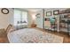 Inviting living room featuring hardwood floors, large rug, neutral paint, and a comfortable home office setup at 3605 Hickory Se Cir, Smyrna, GA 30080