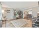 Bright open floorplan living room and dining area featuring hardwood floors, neutral paint, and comfortable home office setup at 3605 Hickory Se Cir, Smyrna, GA 30080