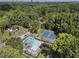 Aerial view of the community pool and tennis courts surrounded by lush trees at 3899 Carlton Dr, Chamblee, GA 30341