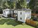 Aerial view of home with a manicured lawn, mature trees, and a fenced backyard at 3899 Carlton Dr, Chamblee, GA 30341