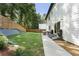 Manicured backyard featuring lush green grass and mature trees, with a seating area perfect for outdoor entertaining at 3899 Carlton Dr, Chamblee, GA 30341