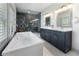 Bright bathroom with a soaking tub, double vanity, and walk-in shower featuring gray marble tile surround at 3899 Carlton Dr, Chamblee, GA 30341