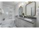 Modern bathroom featuring double sinks, marble floors, and a shower/tub combo at 3899 Carlton Dr, Chamblee, GA 30341