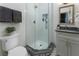 Modern bathroom featuring a glass shower, gray vanity, and contemporary fixtures at 3899 Carlton Dr, Chamblee, GA 30341