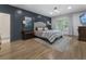 Stylish bedroom features an accent wall, hardwood floors, natural light, and television at 3899 Carlton Dr, Chamblee, GA 30341