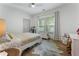 Inviting bedroom featuring a ceiling fan, a comfortable bed, and bright natural light at 3899 Carlton Dr, Chamblee, GA 30341