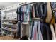 Walk-in closet featuring custom shelving and hanging rods for efficient storage and organization of clothes and shoes at 3899 Carlton Dr, Chamblee, GA 30341