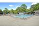 Large community pool has seating areas, umbrellas, and a shallow wading area at 3899 Carlton Dr, Chamblee, GA 30341