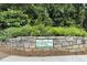 Stone sign featuring the Huntley Hills community name, surrounded by greenery at 3899 Carlton Dr, Chamblee, GA 30341