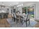 Dining area with a light wood table, upholstered chairs, and a sliding glass door to backyard at 3899 Carlton Dr, Chamblee, GA 30341