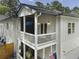 Two-story home exterior with a porch with outdoor furniture and an American flag at 3899 Carlton Dr, Chamblee, GA 30341