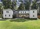 Inviting two-story home featuring a modern gray and white exterior, a manicured lawn, and mature trees at 3899 Carlton Dr, Chamblee, GA 30341