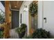 Stylish front door with a wreath, lantern sconces, and a smart doorbell at 3899 Carlton Dr, Chamblee, GA 30341
