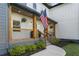 Charming front porch featuring wooden columns, black railings, and decorative landscaping at 3899 Carlton Dr, Chamblee, GA 30341