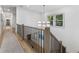 Upstairs hallway features hardwood floors, modern lighting, and railing at 3899 Carlton Dr, Chamblee, GA 30341