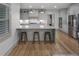 Open kitchen with a marble topped island, grey cabinets and stainless steel appliances at 3899 Carlton Dr, Chamblee, GA 30341