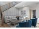 Bright living room features a staircase, contemporary decor, and a comfortable seating arrangement at 3899 Carlton Dr, Chamblee, GA 30341