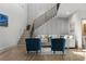 Open-concept living room features a staircase, modern furniture, and bright, airy design at 3899 Carlton Dr, Chamblee, GA 30341