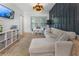 Comfortable living room features a large sectional sofa, a wall-mounted TV, and bright natural light at 3899 Carlton Dr, Chamblee, GA 30341