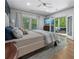 Comfortable main bedroom featuring an outdoor access, a ceiling fan, and large windows at 3899 Carlton Dr, Chamblee, GA 30341