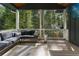 Inviting porch with a comfortable sectional couch, perfect for outdoor relaxation and entertaining with a view of trees at 3899 Carlton Dr, Chamblee, GA 30341