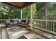 Inviting porch with a comfortable sectional couch, perfect for outdoor relaxation and entertaining with a view of trees at 3899 Carlton Dr, Chamblee, GA 30341