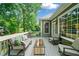 Inviting back deck with comfortable seating, glass-top table, and views of the lush backyard at 501 Avery Creek Pointe, Woodstock, GA 30188