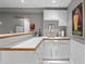 Finished basement bar area with white cabinetry, tiled countertops, and stylish decor at 501 Avery Creek Pointe, Woodstock, GA 30188